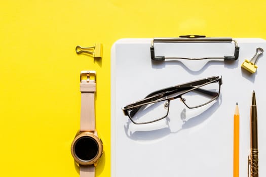 Home office workspace mockup with laptop, clipboard, cotton, coffee, headphones, glasses and accessories.