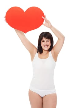 Portrait, heart and happy plus size woman in studio isolated on a white background. Love, sign or symbol of model in underwear with healthy body for care, kindness emoji and romance on valentines day.