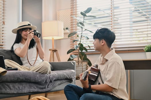 Young asian couple packing cloth and stuff for their holiday travel trip together in living room