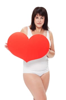 Portrait, red heart poster and woman in studio isolated on a white background. Love, sign and symbol of plus size model in underwear with healthy body for care, kindness and romance on valentines day.