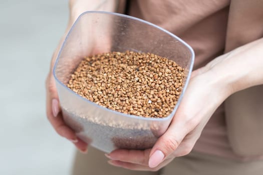 dry buckwheat and hand, healthy food concept . High quality photo