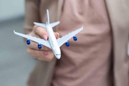 Female woman hands holding small toy model plane. Travel by plane vacation weekend adventure trip journey ticket tour aviation delivery concept. Symbol of international freedom. High quality photo