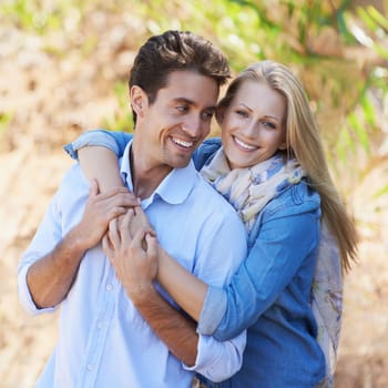 Couple, portrait and happy or hug with travel in forest, nature or outdoor for holiday, vacation or trip. Romance, man and woman with embrace or smile for relationship, date or honeymoon with love.