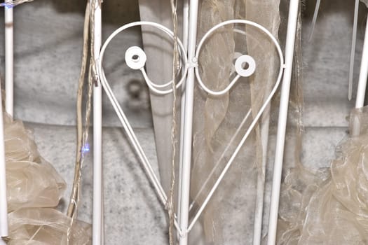 white metal lattice fittings in the shape of a heart, swasch design objects. High quality photo