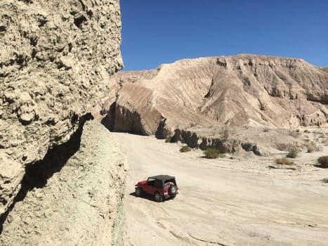 Red SUV Parked by Arroyo Tapiado Mud Caves in Anza Borrego State Park. High quality photo