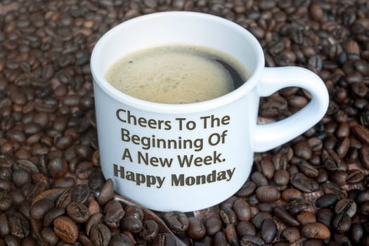 Motivational quote on a cup of coffee with beans background - Cheers to the beginning of a new week. Happy monday.