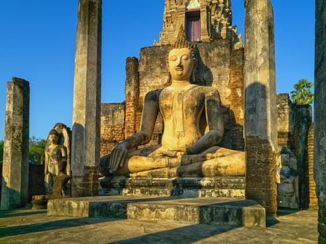 Buddha at Wat Phra Sri Rattana Mahathat Rajaworavuharn temple in Si Satchanalai historical park by day, Thailand