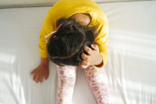 child Scratching her Head closeup