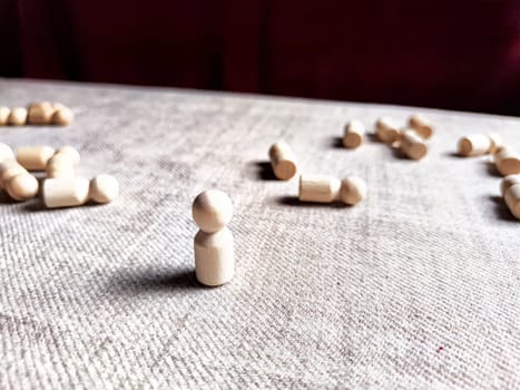 A lot of lying wooden toys and one standing one. There is an opportunity to win even when others give up. The strongest ones win. The loneliness of leader in business