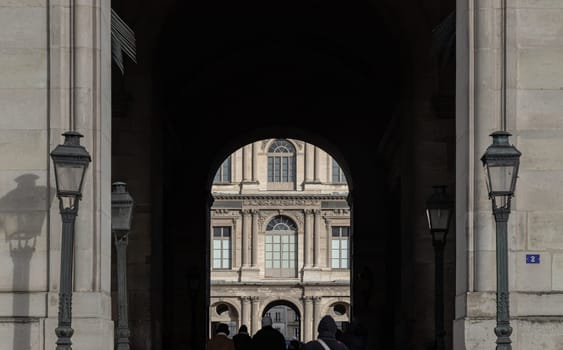 France, Paris - Jan 03, 2024 - Archway to the Louvre courtyards. Louvre Museum outside during day time, is one of the world's largest museums in Paris, Space for text, Selective focus.