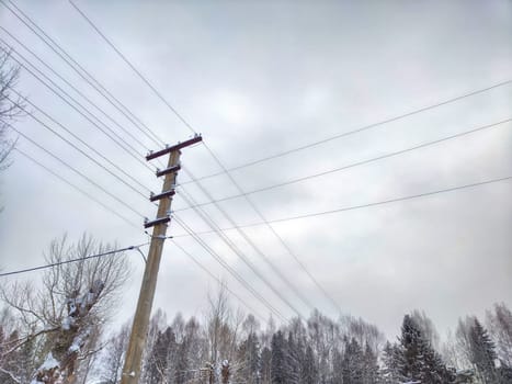 Old pole with wires against the sky. Electric transmission line, Eco-friendly energy