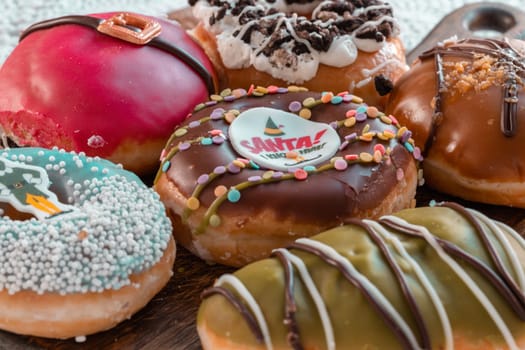 Many Glazed Doughnuts placed on wooden cutting board. The concept of delicious delicious amazing glazed donuts, Space for text, Selective Focus.