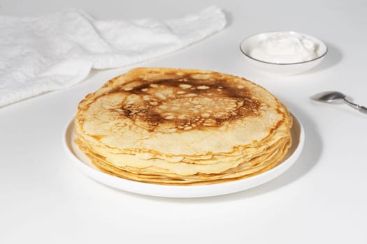 Thin pancakes in a plate. Concept of delicious breakfast or Maslenitsa.