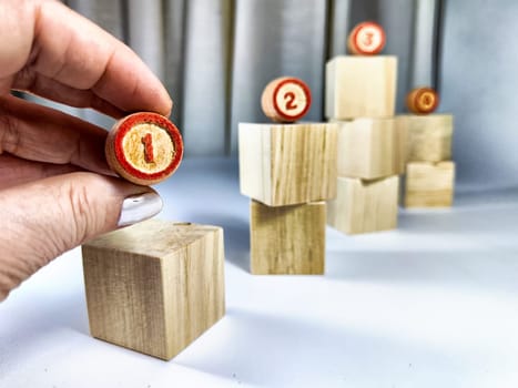 Small wooden cubes in columns, lined up in a row. The concept of progressive movement in achieving the goal. Steps and stages of project development and implementation