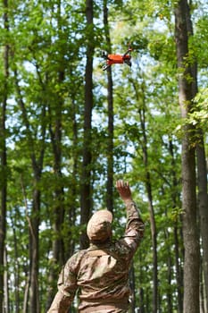 Elite military unit, equipped with state-of-the-art technology including a drone, strategically navigates and surveys dangerous wooded terrain, showcasing their precision, cooperation, and specialized training for high-risk operations.