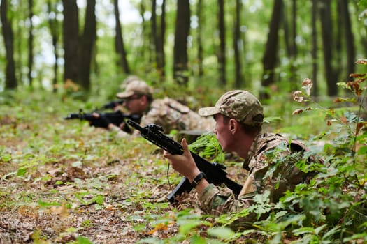 Elite soldiers stealthily maneuver through the dense forest, camouflaged in specialized gear, as they embark on a covert and strategic military mission.