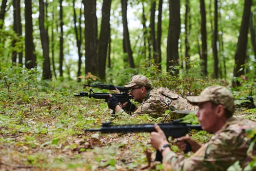 Elite soldiers stealthily maneuver through the dense forest, camouflaged in specialized gear, as they embark on a covert and strategic military mission.