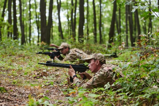 Elite soldiers stealthily maneuver through the dense forest, camouflaged in specialized gear, as they embark on a covert and strategic military mission.