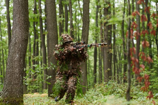 A highly skilled elite sniper, camouflaged in the dense forest, stealthily maneuvers through dangerous woodland terrain on a covert and precise mission.