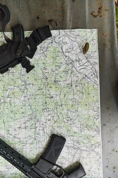 An array of military weapons, including rifles and pistols, is meticulously arranged on a table in a military base, presenting a close-up view of the diverse firepower and armament meticulously organized for readiness and strategic deployment.