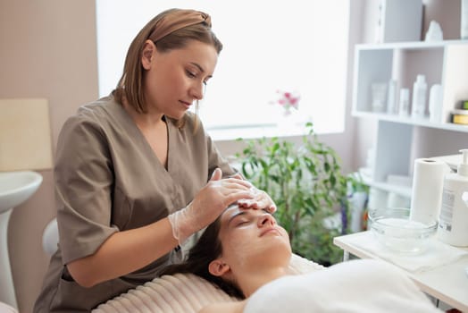 Cosmetologist gets ready for ultrasonic face cleaning procedure in professional beauty salon