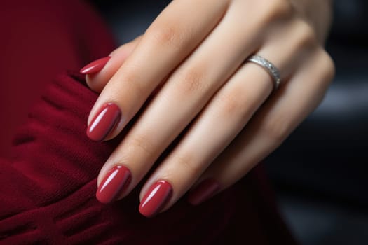 Close-up of the hands of a young woman with bright red manicure on her nails. ai generated