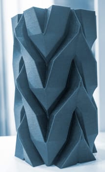 Art object vase printed on a 3D printer. Models created by a 3D printer from blue molten plastic. Concept 3d printing. Additive progressive technologies. New modern technology for creating objects