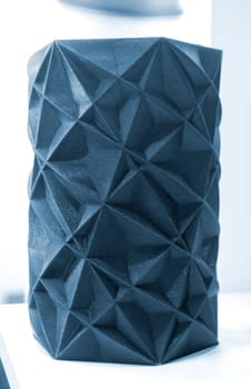 Art object vase printed on a 3D printer. Models created by a 3D printer from blue molten plastic. Concept 3d printing. Additive progressive technologies. New modern technology for creating objects