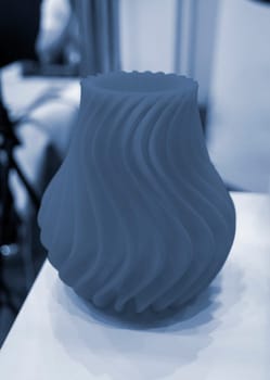 Art object vase printed on a 3D printer. Models created by a 3D printer from blue molten plastic. Concept 3d printing. Additive progressive technologies. New modern technology for creating objects