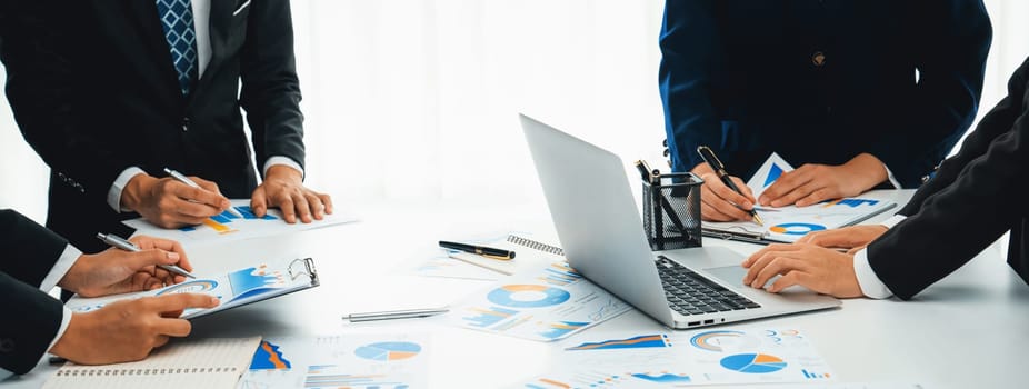 Business people in group meeting in formal attire share idea discussing report for company profit in creative workspace for start up business shot in close up view on group meeting table . Oratory .