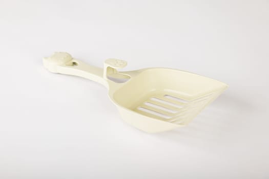 Isolated on a clean white background metal cat litter scoops are essential for maintaining hygiene and cleanliness in your cat's litter box. Purity and care are a scoop away.