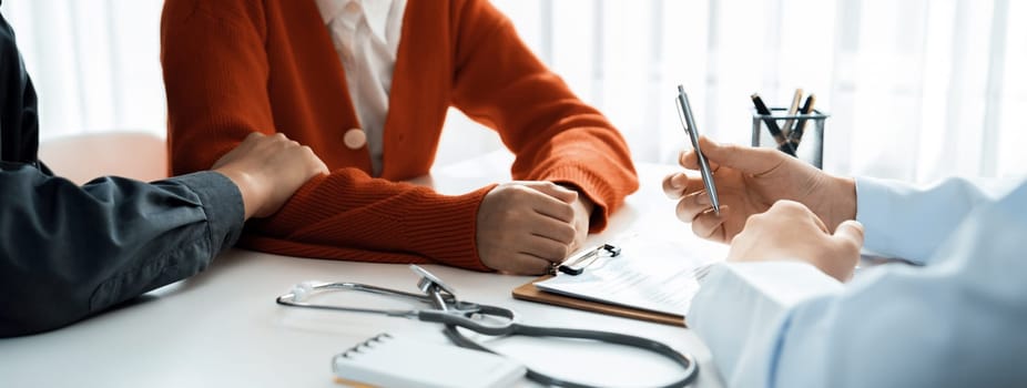 Couple attend fertility or medical consultation with gynecologist at hospital as family planning care for pregnancy. Husband and wife consoling each other through doctor appointment. Panorama Rigid