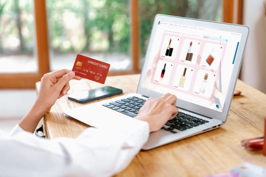 Woman shopping online on internet marketplace browsing for sale items for modern lifestyle and use credit card for online payment from wallet protected by uttermost cyber security software