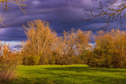 Picturesque atmosphere in the evening with dramatic clouds in sunshine and autumnal colors, Germany