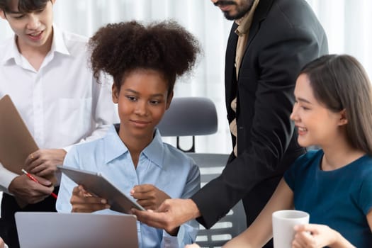 Happy diverse business people work together, discussing in corporate office. Professional and diversity teamwork discuss business plan on desk with laptop. Modern multicultural office worker. Concord