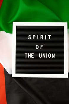 Text SPIRIT OF THE UNION on background flag of UAE. National holiday of United Arab Emirates. Commemoration Day Muslim Arabian holidays. Dubai celebration