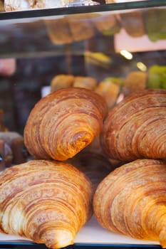 fresh baked croissant in a bakery .