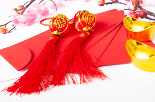 Chinese New Year red packet and golden ingot. Chinese New Year celebration concept.