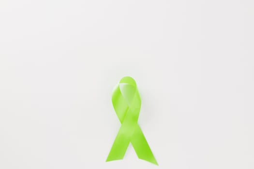Green awareness ribbon symbol of Gallbladder and Bile Duct Cancer month isolated on white background with copy space, concept of medical and health care support, Cancer awareness, World bipolar day