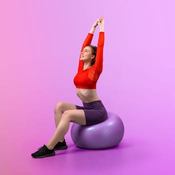 Full body length gaiety shot athletic and sporty young woman with fitness exercising ball in standing posture on isolated background. Healthy active and body care lifestyle.