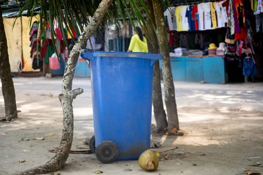 blue garbage can sitting in front of shops in havelock swaraj dweep beach andaman and nicobar island India