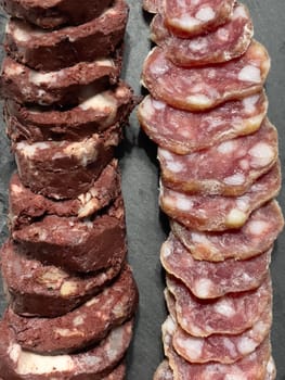 Slices of sausage and meat pudding on a plate, top view, High quality photo