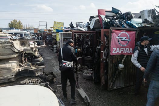 car parts at open air junkyard and used spare parts market in Kudaybergen, Bishkek, Kyrgyzstan - November 5, 2022