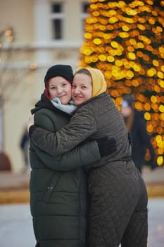 Mom and teenage daughter at an ice rink in Denmark at Christmas.