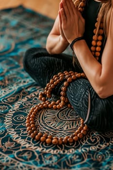 Yoga Buddhist woman with rosary in hands. Selective focus. People.