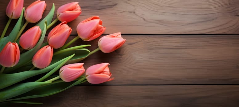 A bouquet of pink tulips arranged elegantly on a polished wooden surface, emphasizing contrast and natural beauty.
