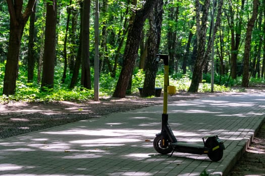 Electric scooter on the alley in the park.