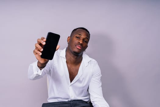 African American millennial businessman isolated on a studio background, successful male formal suit