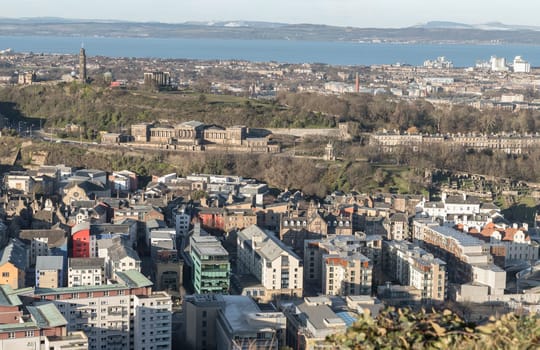 Edinburgh, Scotland - Jan 17, 2024 - Amazing Edinburgh cityscape and Leith docks with the skyline seen from the top of Salisbury Crags. Destinations in Europe, Space for text, Selective focus.