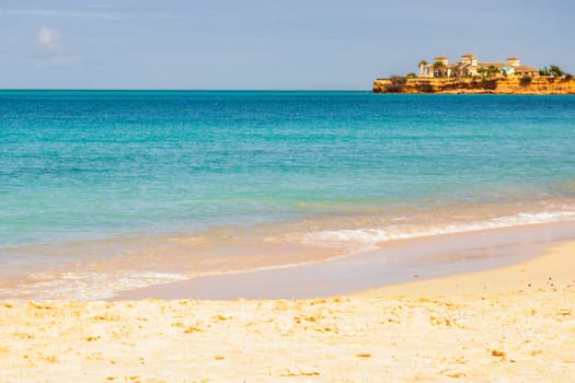 Caribbean beach with white sand, deep blue sky and turquoise water